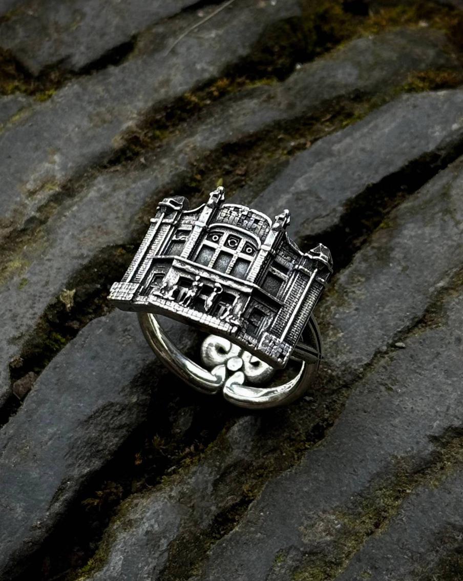 Крошечные скульптуры на кольце отсылают к барельефу на стене отеля "Метрополь".