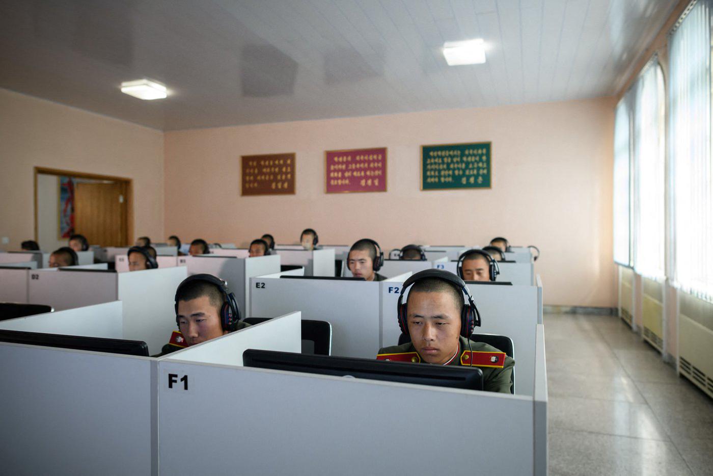 Учащиеся в форме Корейской народной армии  сидят за компьютерами во время занятий в элитном Мангендэском революционном училище.