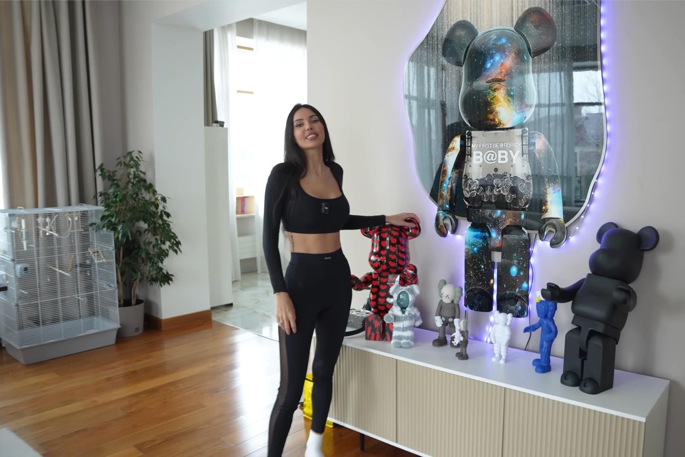 На тумбе собрана коллекция дизайнерских арт-игрушек BE@RBRICK и фигурок в эстетике KAWS.